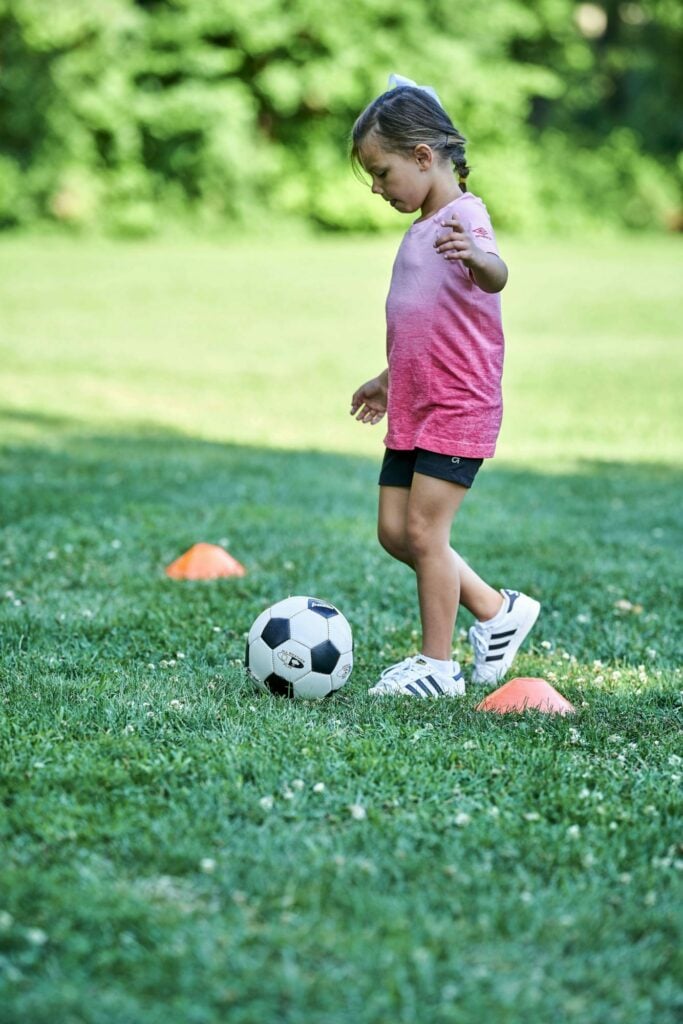 young girl playing soccer