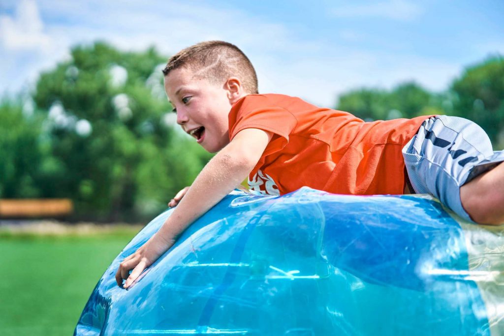 Boy on top of an inflatable ball