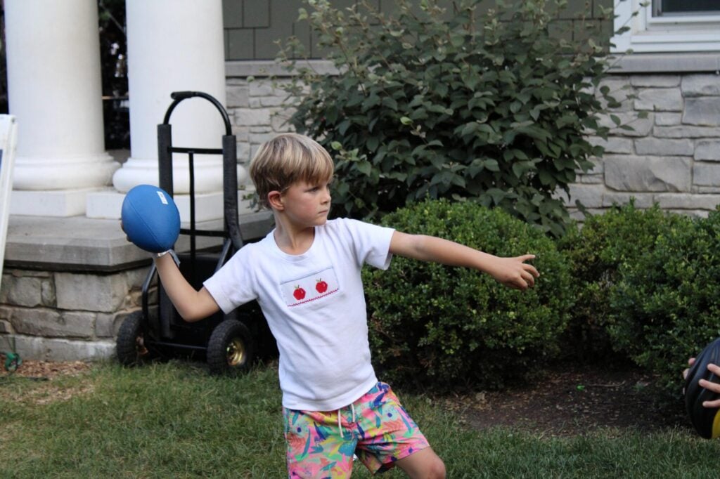 Young boy throwing football