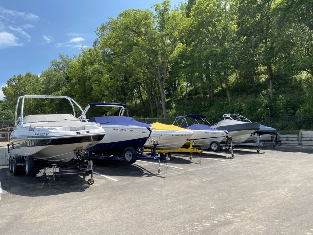 six motorized boats sitting in fenced-in storage at Lloyd Beach