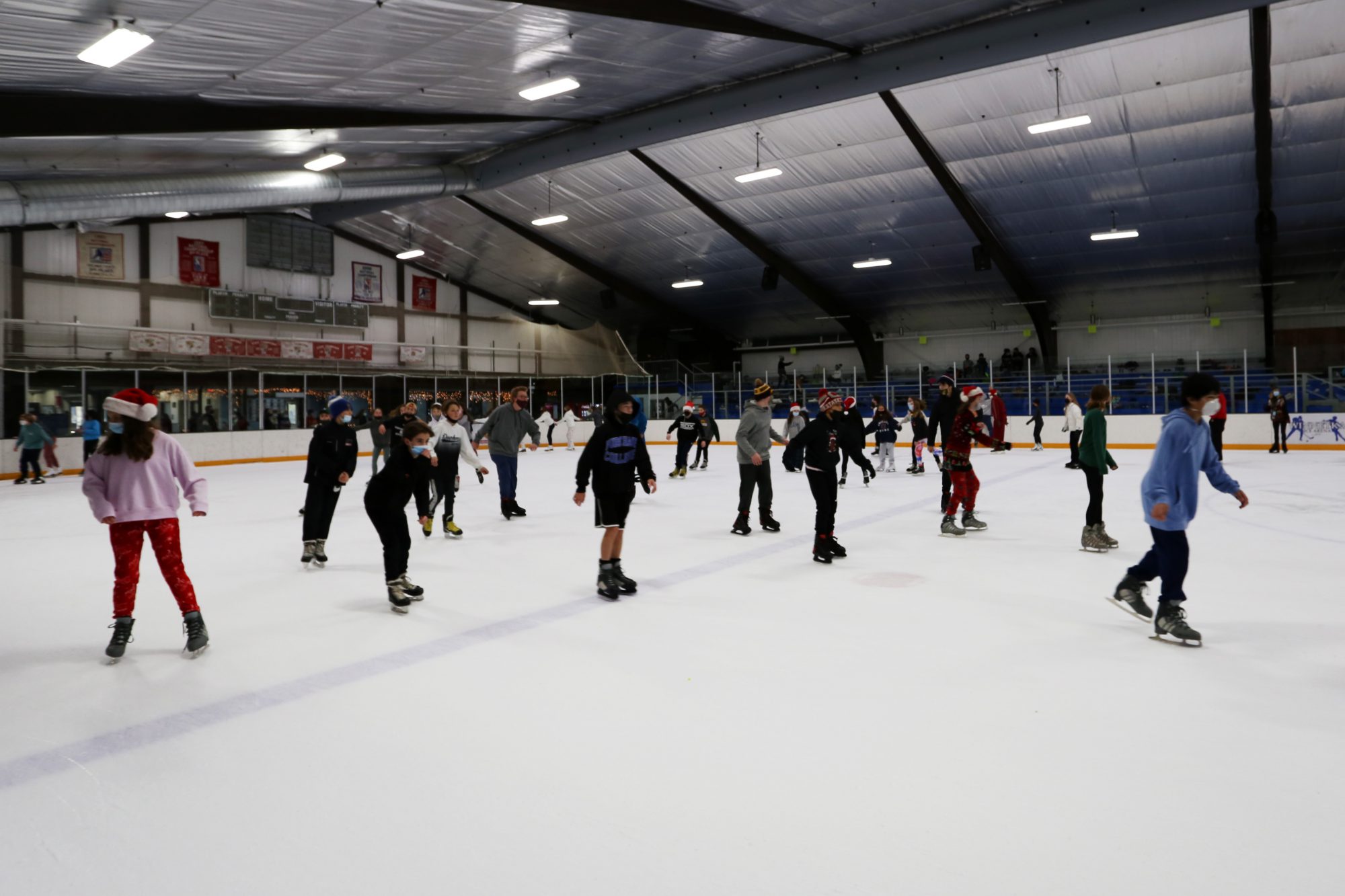 large group of children skating at a public skate