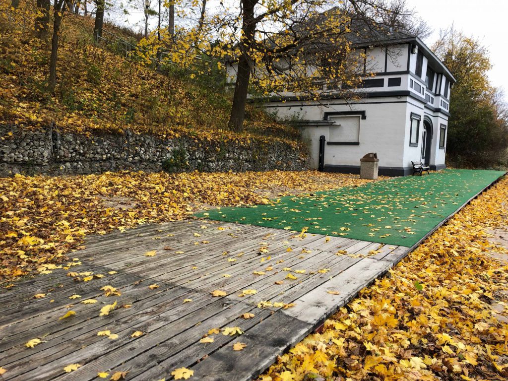 Maple Street Beach boardwalk covered in leaves