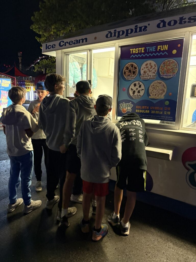 Group of boys standing outside of Dippin Dots truck ordering