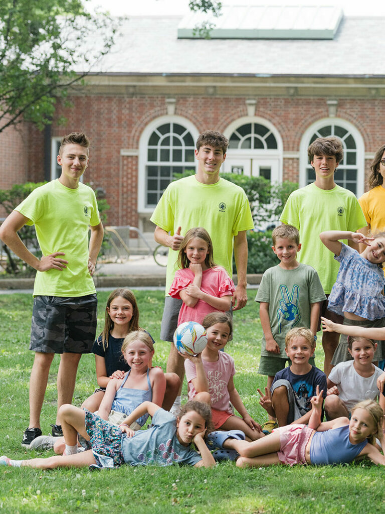 Campers and camp counselors smiling for a picture.