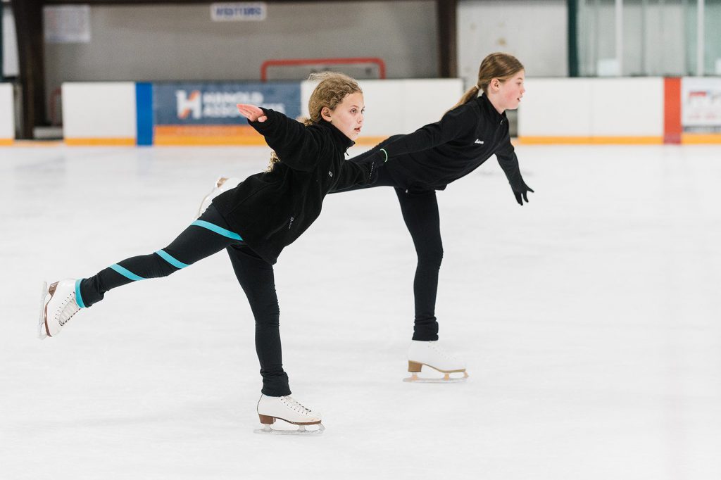 two girls performing a skate routine